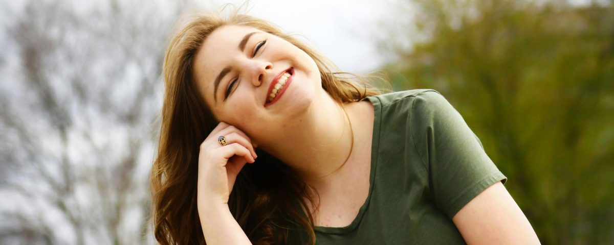 pexels-photo-1062280-1062280 A carefree woman enjoying a sunny day outdoors, expressing pure happiness and relaxation.